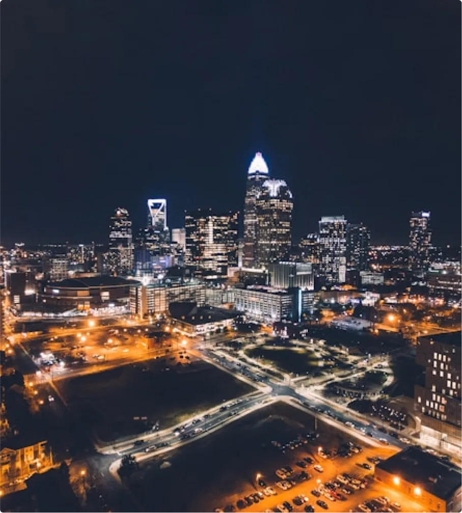 Nighttime aerial image of uptown Charlotte, NC