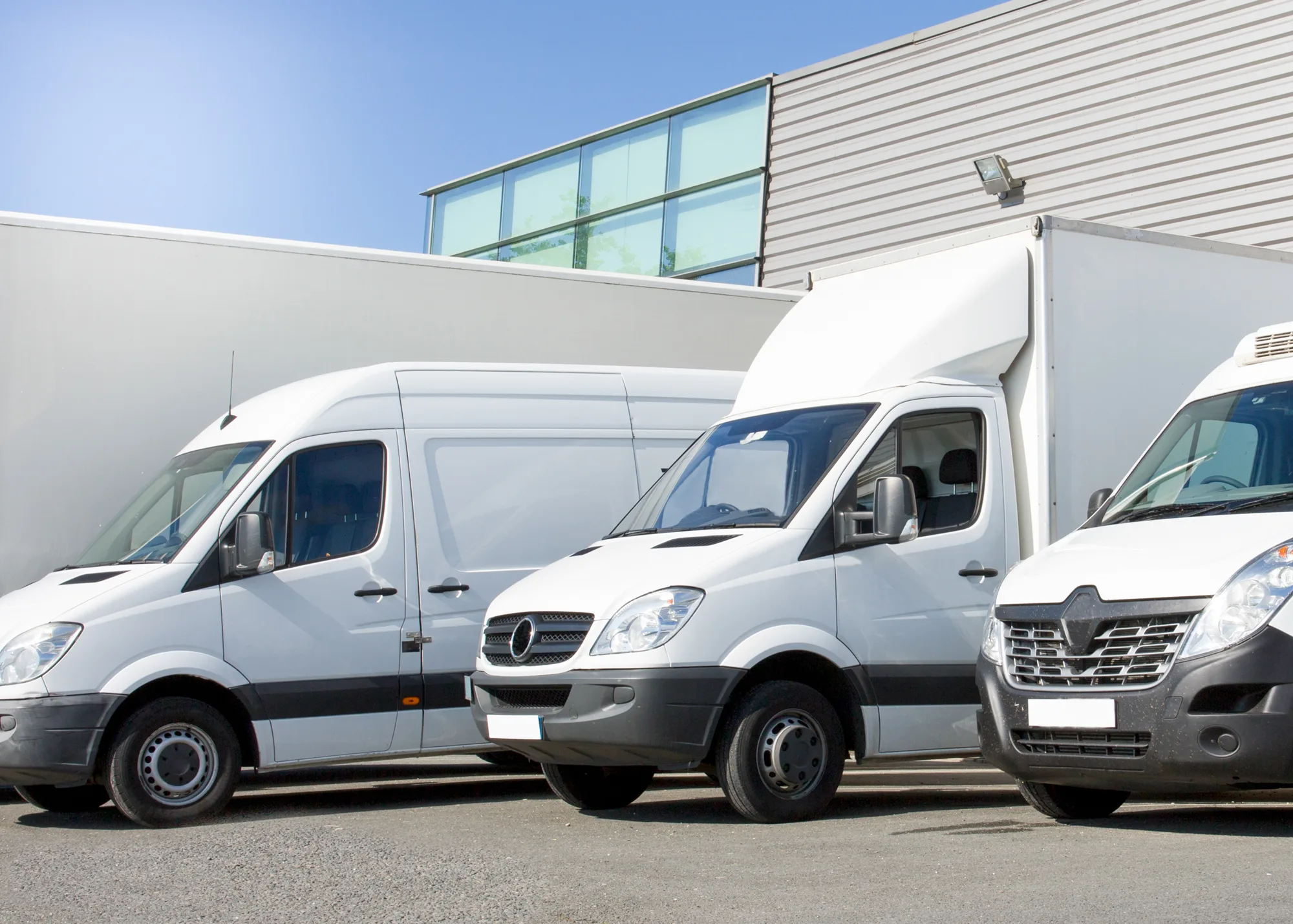 A group of white fleet vehicles