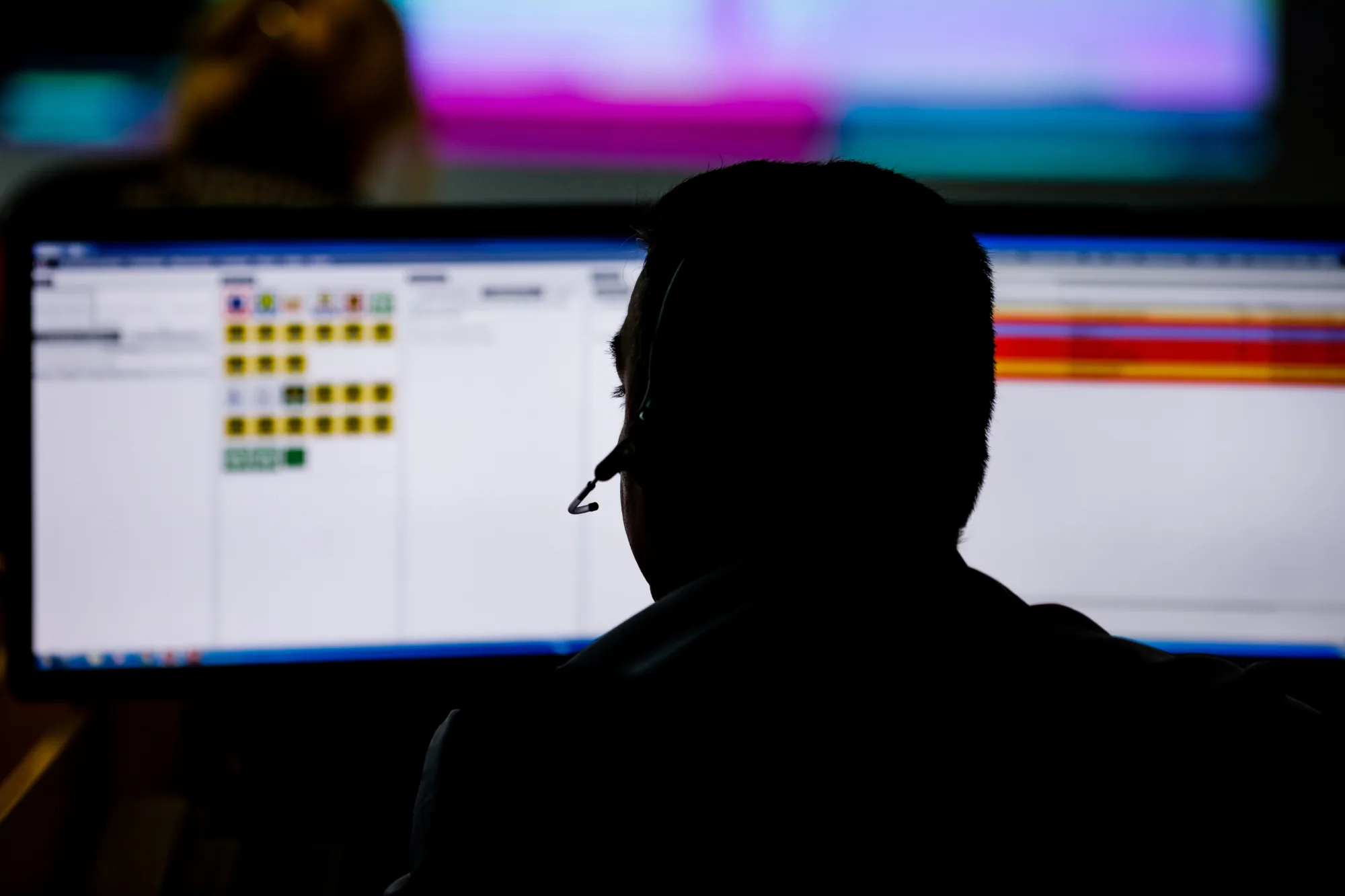 Shallow depth of field (selective focus) image with emergency number operator having a conversation with a distressed caller